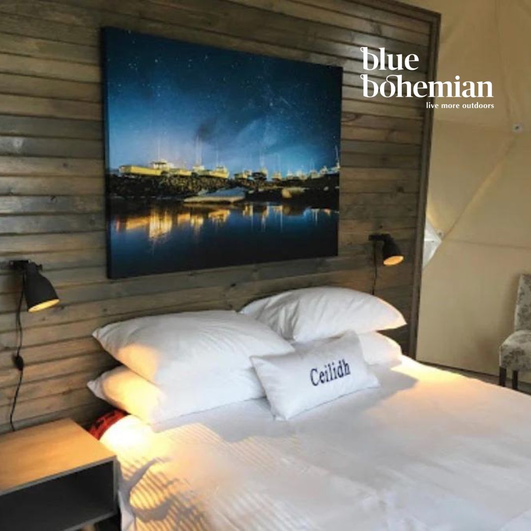Geodesic dome with wooden wall, large TV screen, and 'blue bohemian' branding.